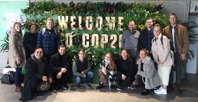 Photo of Schar School students in front of a COP26 sign in Scotland
