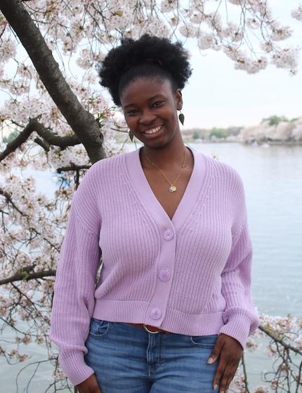 Celine Apenteng with cherry blossoms and river view